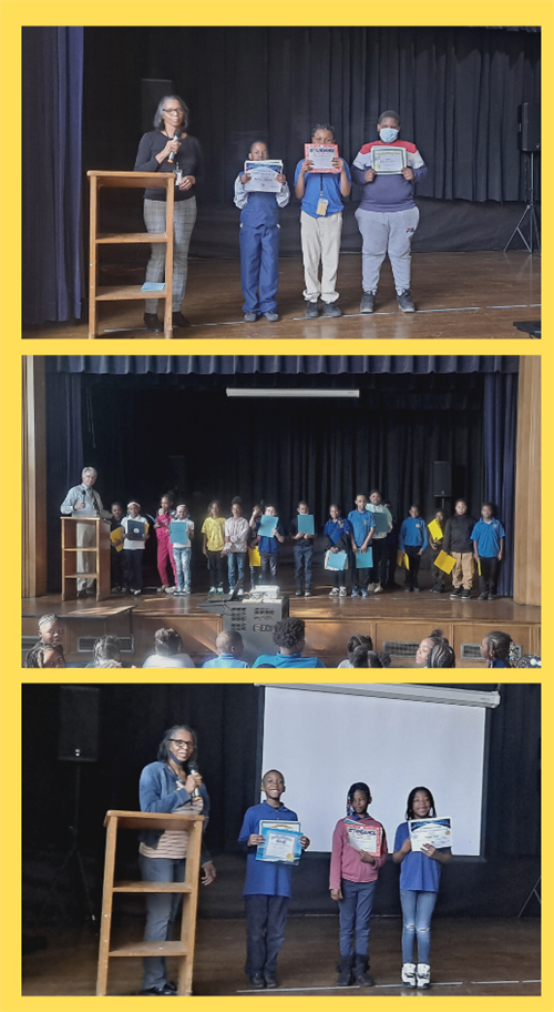 students on stage with certificaes